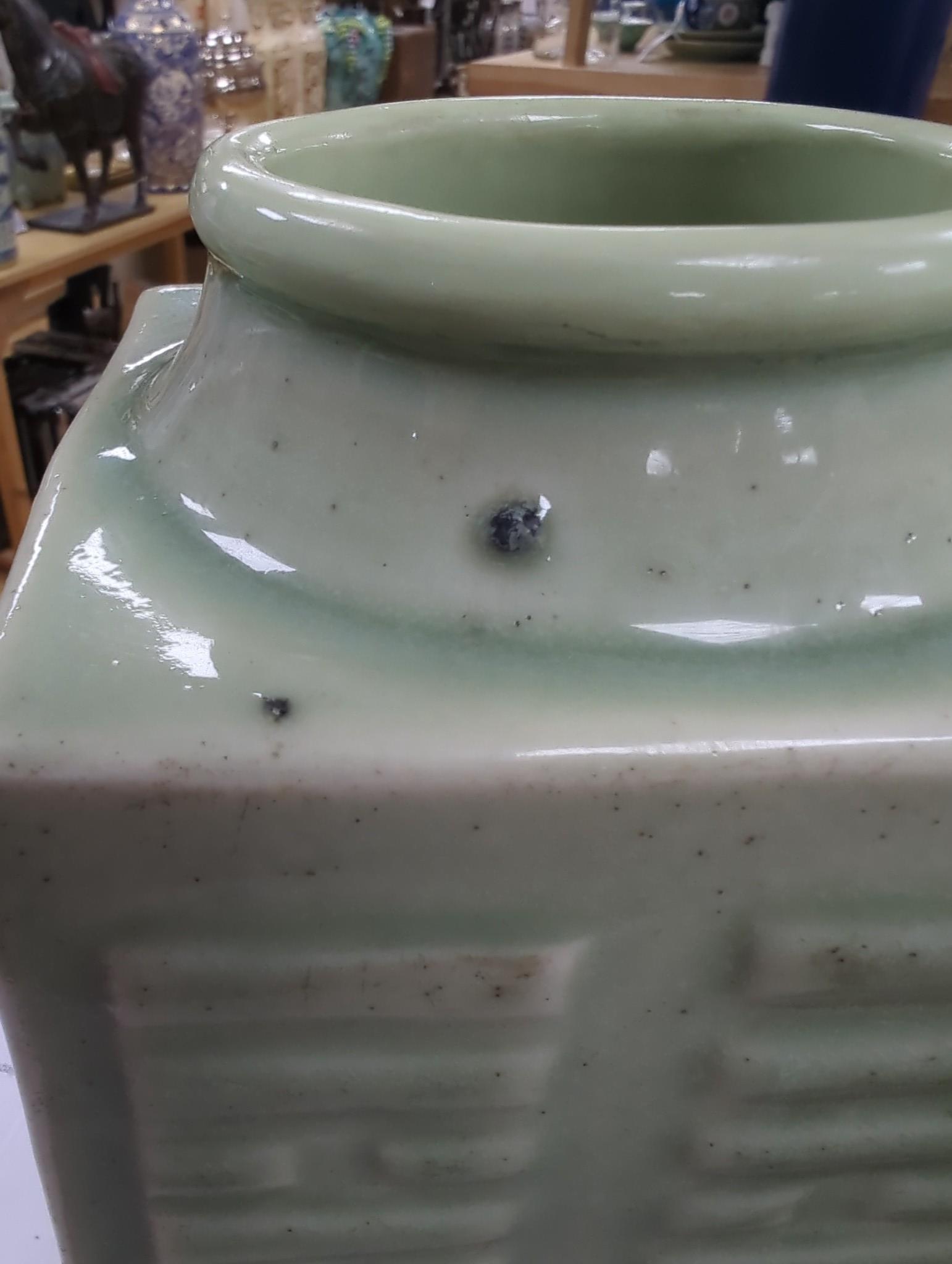 A pair of early 20th century Chinese celadon glazed eight trigrams cong vases, 25cm